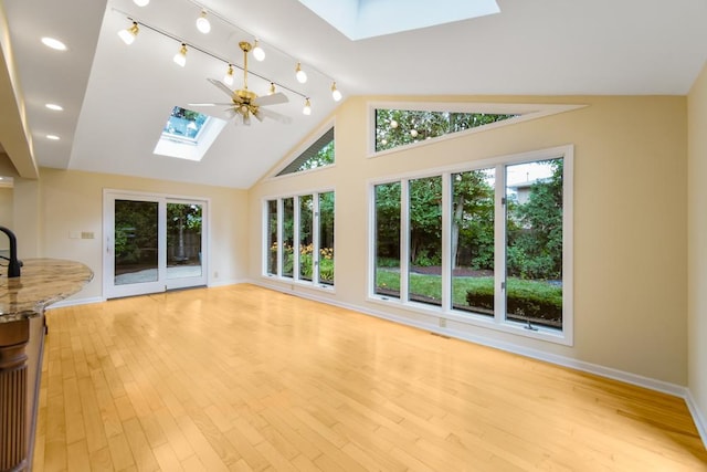 1234 Will Dr, Lockport, IL 60441 - unfurnished living room featuring a skylight, lofted ceiling, light wood-type flooring, and a ceiling fan