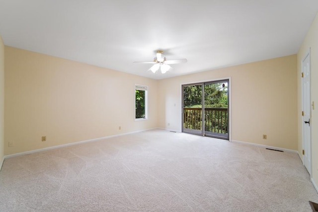 1234 Will Dr, Lockport, IL 60441 - unfurnished room featuring light colored carpet, plenty of natural light, and ceiling fan