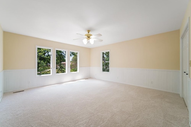 1234 Will Dr, Lockport, IL 60441 - carpeted spare room featuring wainscoting and a ceiling fan