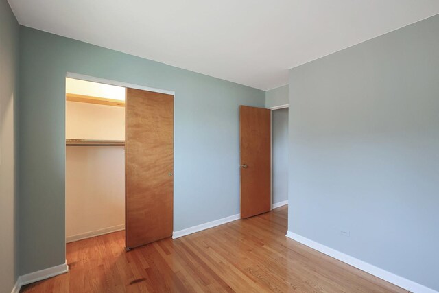 9043 Oriole Ave, Morton Grove, IL 60053 - unfurnished bedroom featuring wood finished floors and a closet