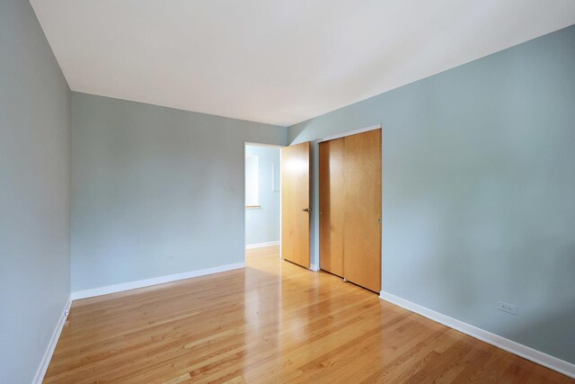 9043 Oriole Ave, Morton Grove, IL 60053 - unfurnished bedroom featuring two closets and light wood-style flooring