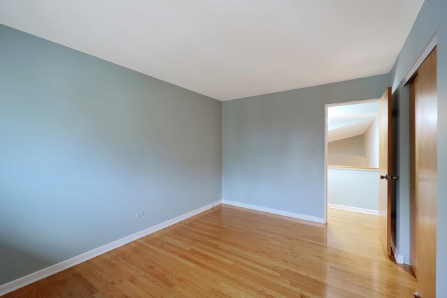 9043 Oriole Ave, Morton Grove, IL 60053 - unfurnished bedroom with multiple closets and light wood-style flooring