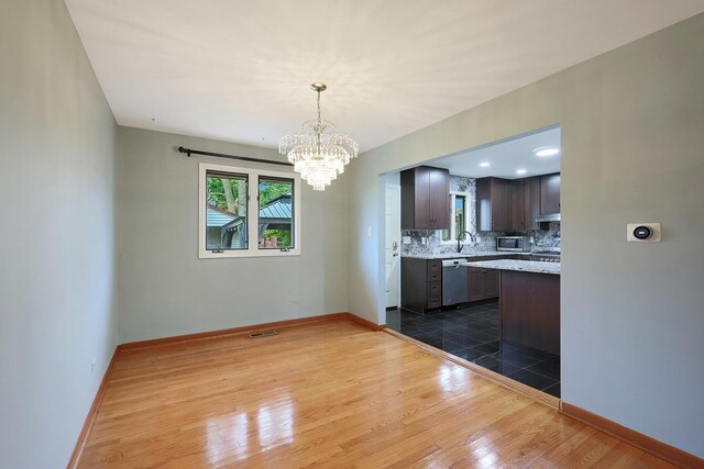 9043 Oriole Ave, Morton Grove, IL 60053 - kitchen with dark tile patterned flooring, recessed lighting, a chandelier, dark brown cabinets, and hanging light fixtures