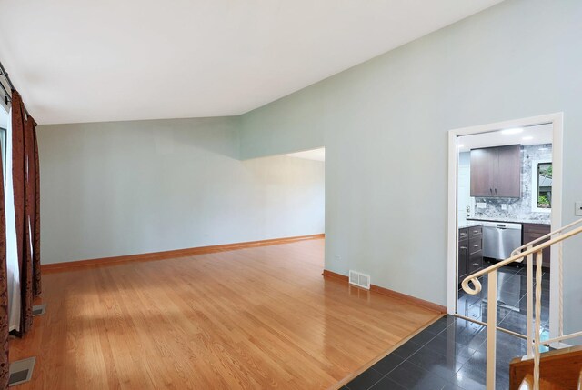 9043 Oriole Ave, Morton Grove, IL 60053 - kitchen featuring appliances with stainless steel finishes, backsplash, dark tile patterned flooring, a chandelier, and light stone counters