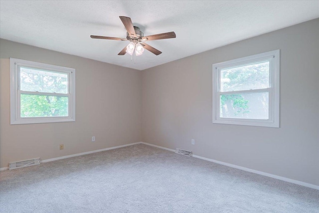 107 S Regency Dr, Bloomington, IL 61701 - unfurnished room with healthy amount of natural light, carpet, and ceiling fan