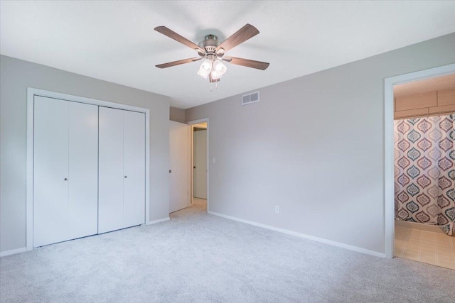 107 S Regency Dr, Bloomington, IL 61701 - unfurnished bedroom featuring light colored carpet, a closet, ensuite bathroom, and ceiling fan