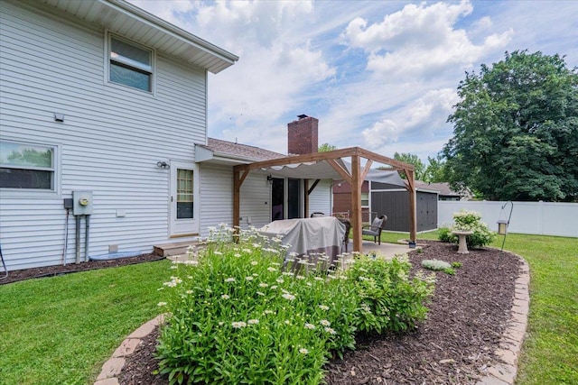 107 S Regency Dr, Bloomington, IL 61701 - back of house with a chimney, a storage unit, and a patio area