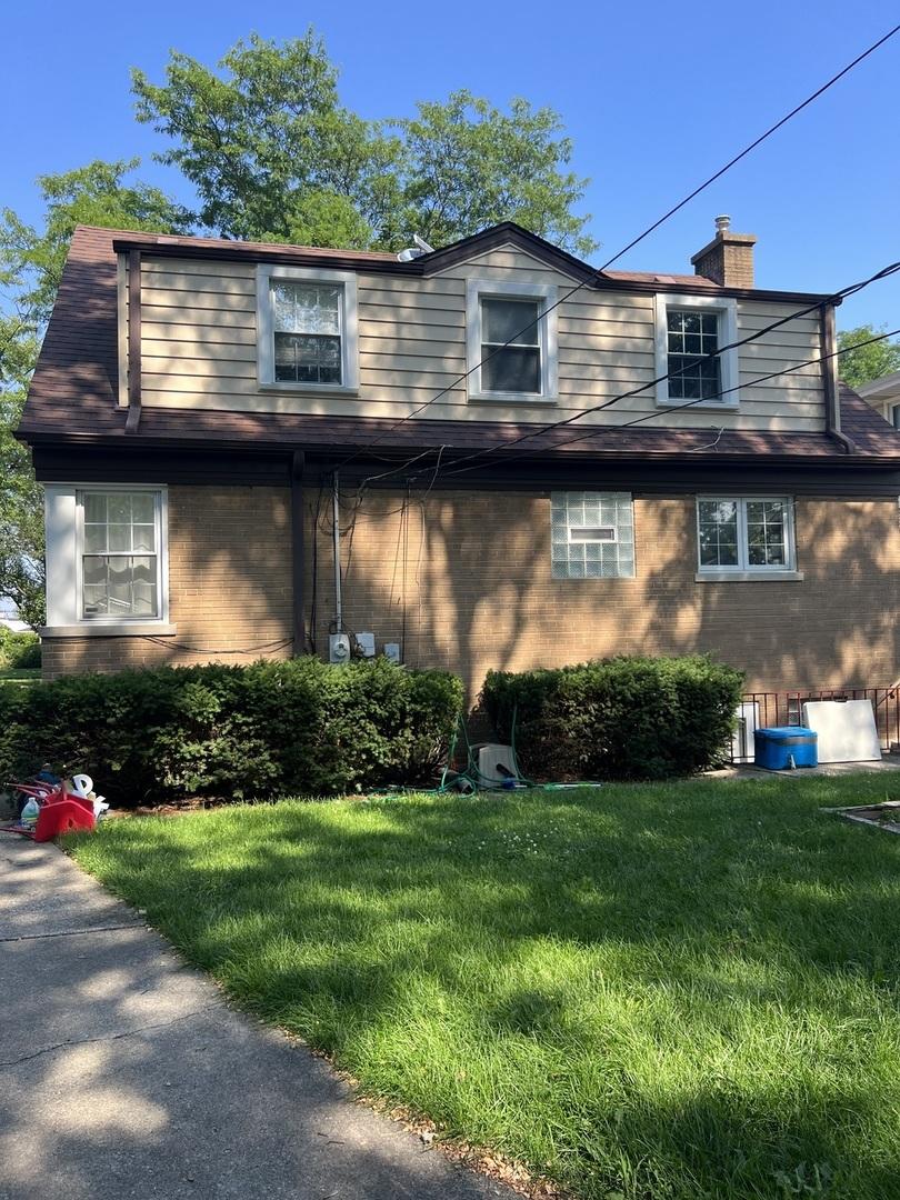 1860 Belleview Ave, Westchester, IL 60154 - view of front of property with a front lawn, brick siding, and a chimney