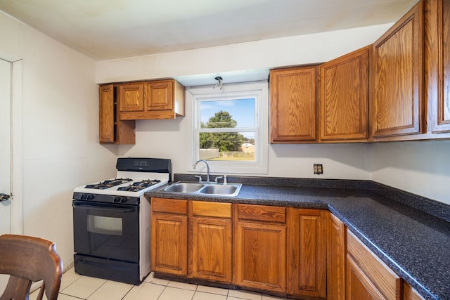 8116 Leamington St, Burbank, IL 60459 - kitchen featuring gas range, brown cabinets, light tile patterned floors, and dark countertops
