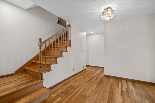 15893 Aime Ln, Wadsworth, IL 60083 - stairs with wood finished floors, a chandelier, and recessed lighting