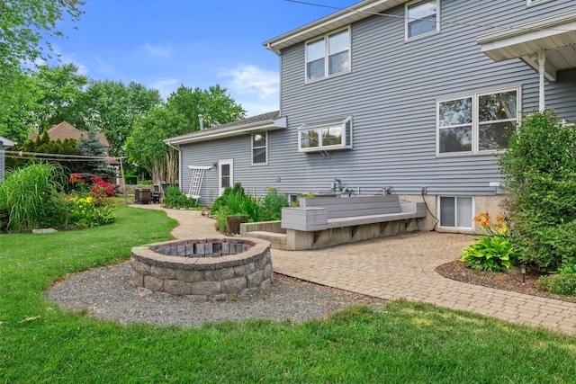 15893 Aime Ln, Wadsworth, IL 60083 - rear view of house featuring a lawn, an outdoor fire pit, and a patio area