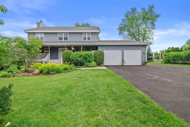 15893 Aime Ln, Wadsworth, IL 60083 - view of front of house featuring a garage, asphalt driveway, a front yard, a chimney, and a porch