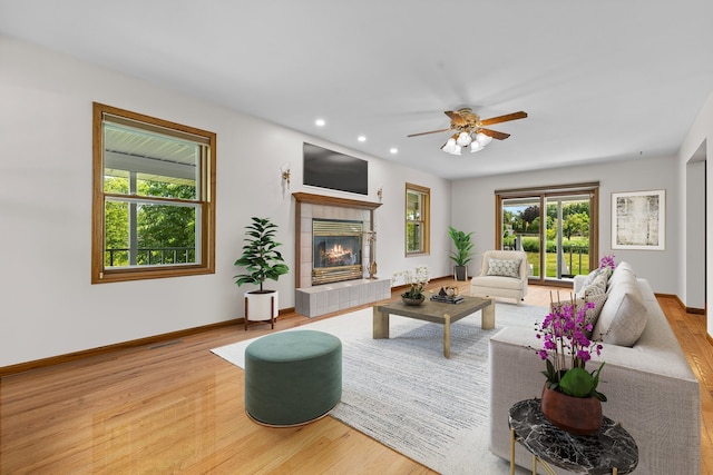 15893 Aime Ln, Wadsworth, IL 60083 - living area featuring wood finished floors, healthy amount of natural light, recessed lighting, a tiled fireplace, and a ceiling fan