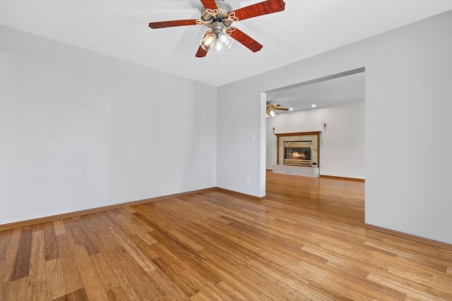 15893 Aime Ln, Wadsworth, IL 60083 - empty room featuring ceiling fan, light wood-style floors, and a tile fireplace