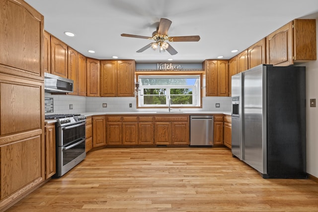 15893 Aime Ln, Wadsworth, IL 60083 - kitchen with stainless steel appliances, light wood-type flooring, light countertops, brown cabinetry, and recessed lighting