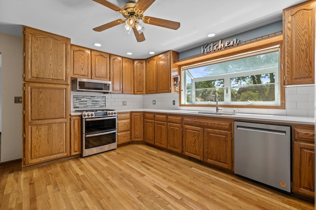 15893 Aime Ln, Wadsworth, IL 60083 - kitchen with appliances with stainless steel finishes, brown cabinetry, tasteful backsplash, light wood-type flooring, and recessed lighting