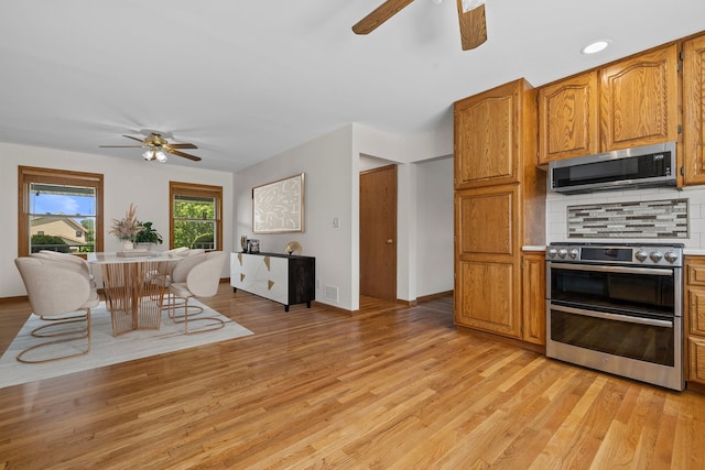 15893 Aime Ln, Wadsworth, IL 60083 - kitchen with appliances with stainless steel finishes, ceiling fan, light wood-style flooring, and tasteful backsplash
