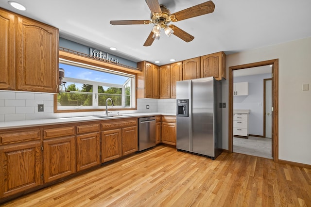15893 Aime Ln, Wadsworth, IL 60083 - kitchen with appliances with stainless steel finishes, brown cabinetry, light wood-style flooring, backsplash, and light countertops
