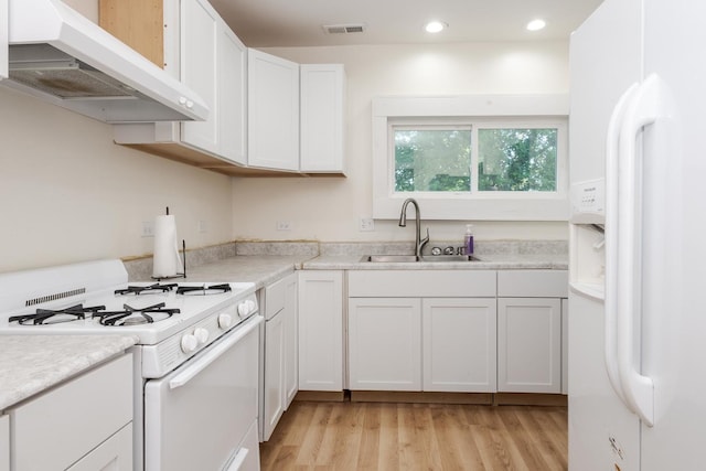 411 E Mazon St, Gardner, IL 60424 - kitchen with white appliances, under cabinet range hood, light wood finished floors, recessed lighting, and white cabinets