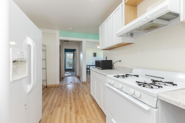 411 E Mazon St, Gardner, IL 60424 - kitchen featuring white appliances, under cabinet range hood, light countertops, and white cabinetry