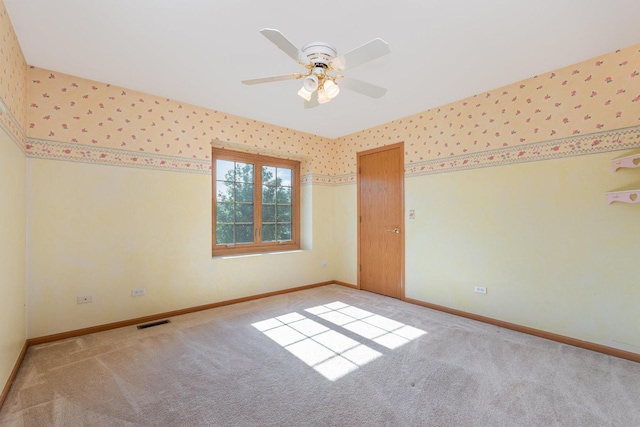 641 Downing St, New Lenox, IL 60451 - spare room featuring light colored carpet, a ceiling fan, and wallpapered walls