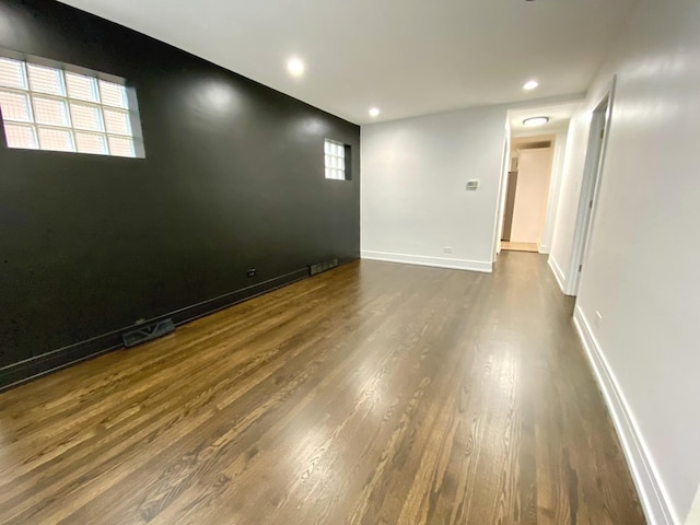 spare room featuring dark wood finished floors and recessed lighting