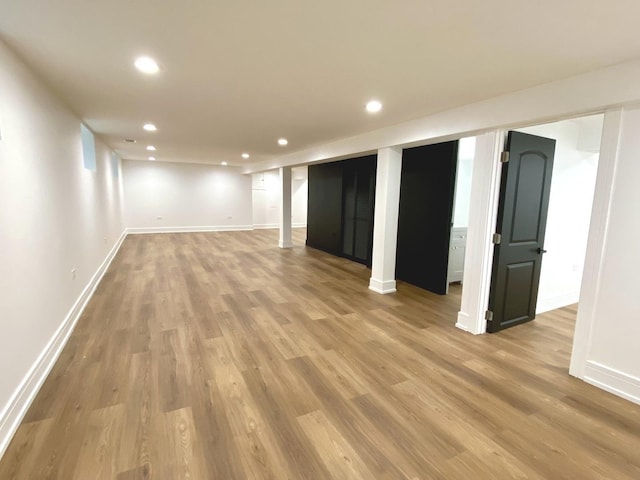 finished below grade area featuring recessed lighting and wood finished floors