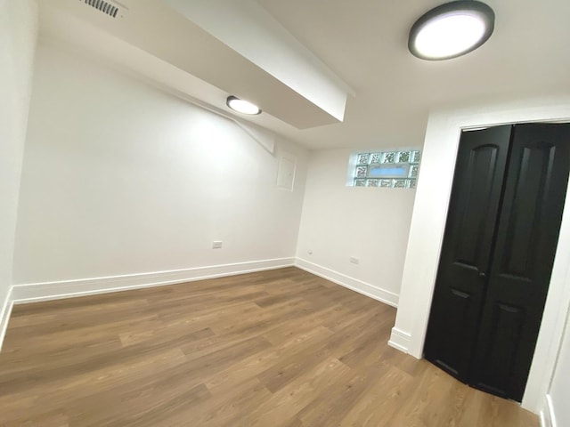 bonus room featuring baseboards and wood finished floors