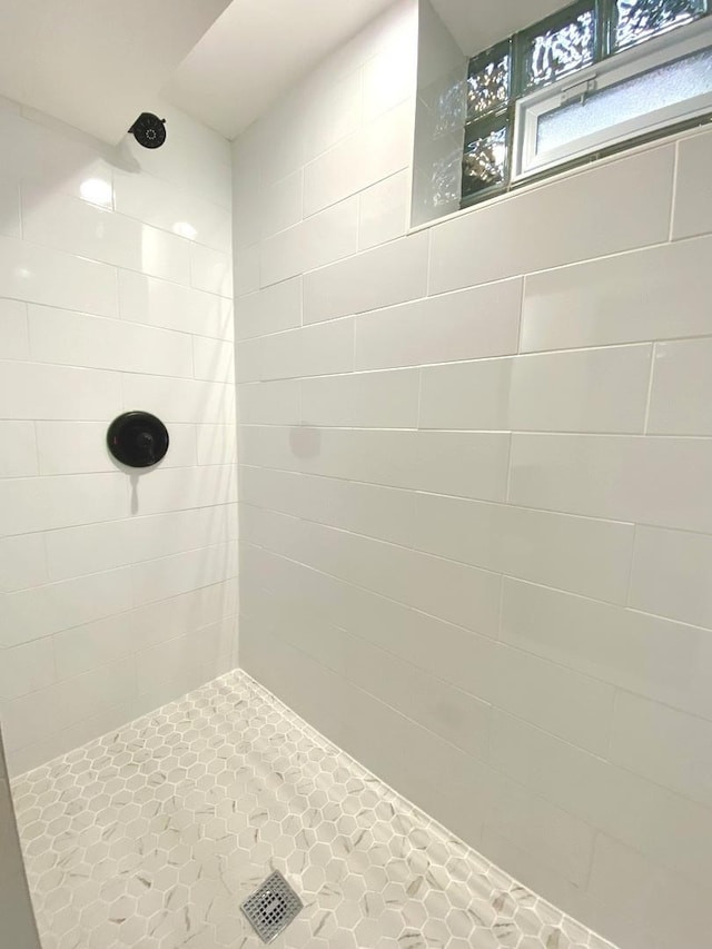 full bath featuring tiled shower