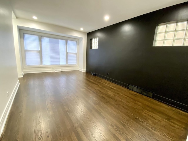 unfurnished room with wood finished floors and recessed lighting