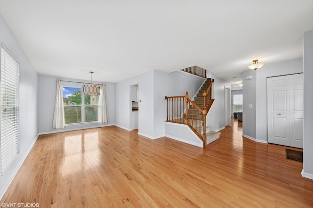 474 Wildflower Way, Bolingbrook, IL 60440 - unfurnished living room with stairway and light wood-style flooring