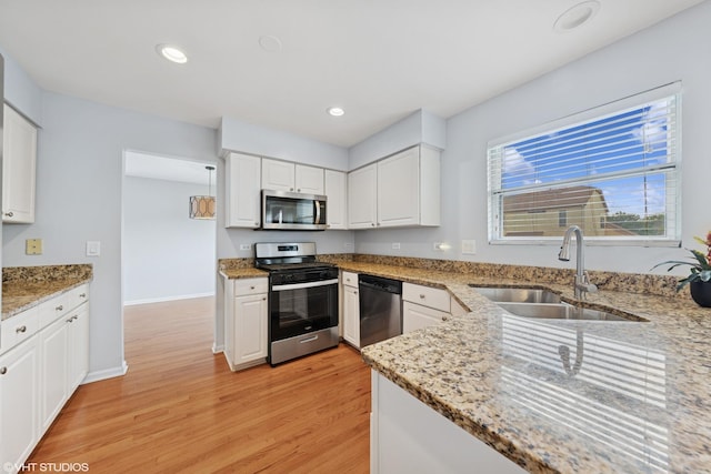 474 Wildflower Way, Bolingbrook, IL 60440 - kitchen featuring appliances with stainless steel finishes, light wood-type flooring, white cabinetry, light stone countertops, and recessed lighting