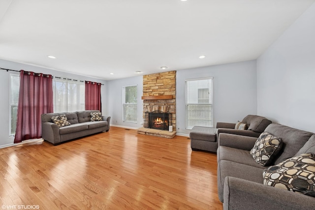 474 Wildflower Way, Bolingbrook, IL 60440 - living area with light wood-type flooring, healthy amount of natural light, a stone fireplace, and recessed lighting