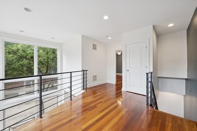 1701 N Washtenaw Ave Unit 1E, Chicago, IL 60647 - empty room featuring wood finished floors and recessed lighting