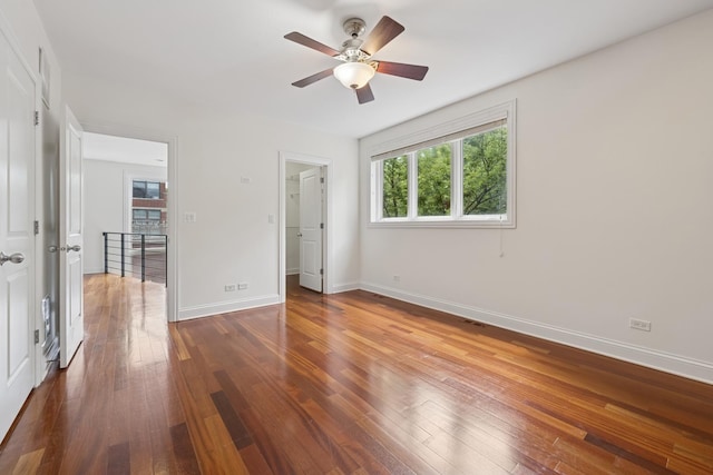 1701 N Washtenaw Ave Unit 1E, Chicago, IL 60647 - unfurnished bedroom featuring hardwood / wood-style flooring, a walk in closet, and ceiling fan