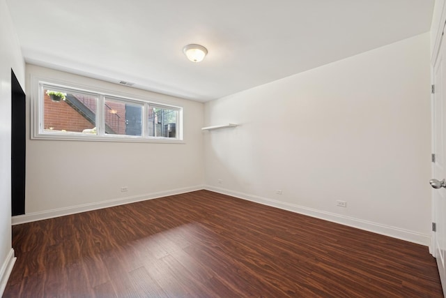1701 N Washtenaw Ave Unit 1E, Chicago, IL 60647 - unfurnished room featuring dark wood-type flooring and baseboards