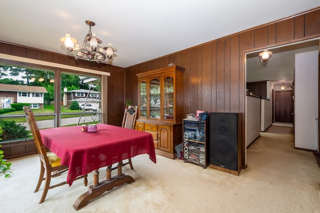 874 Hillandale Dr, Antioch, IL 60002 - dining area with a chandelier, light colored carpet, and wooden walls