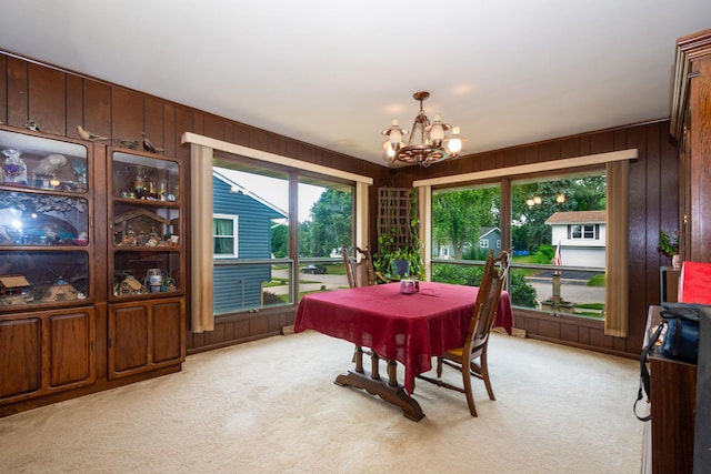 874 Hillandale Dr, Antioch, IL 60002 - dining space featuring a chandelier, light colored carpet, plenty of natural light, and wood walls