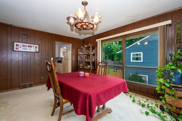 874 Hillandale Dr, Antioch, IL 60002 - carpeted dining space featuring a chandelier and wooden walls
