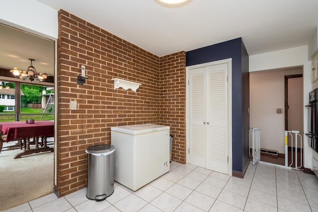 874 Hillandale Dr, Antioch, IL 60002 - washroom with light tile patterned floors, a chandelier, and brick wall