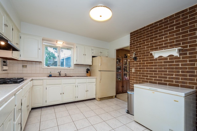 874 Hillandale Dr, Antioch, IL 60002 - kitchen featuring white refrigerator, freestanding refrigerator, black gas stovetop, light countertops, and brick wall
