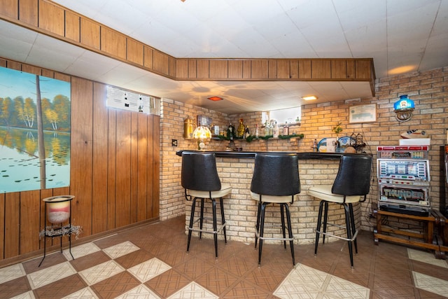 874 Hillandale Dr, Antioch, IL 60002 - indoor dry bar featuring wood walls, tile patterned floors, and brick wall