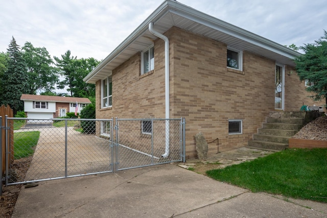 874 Hillandale Dr, Antioch, IL 60002 - view of property exterior with a gate, brick siding, and driveway