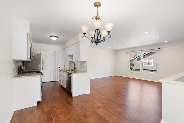 2725 Weeping Willow Dr Unit D, Lisle, IL 60532 - kitchen featuring stainless steel appliances, decorative backsplash, a chandelier, white cabinets, and dark wood-type flooring