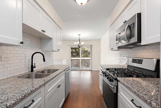 2725 Weeping Willow Dr Unit D, Lisle, IL 60532 - kitchen featuring appliances with stainless steel finishes, white cabinetry, dark wood-style floors, and a chandelier
