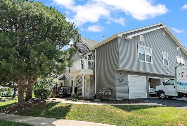 2725 Weeping Willow Dr Unit D, Lisle, IL 60532 - view of home's exterior featuring a garage, a lawn, driveway, and a balcony