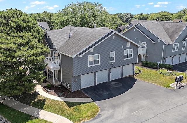 2725 Weeping Willow Dr Unit D, Lisle, IL 60532 - view of side of property with asphalt driveway, a garage, a balcony, a lawn, and roof with shingles