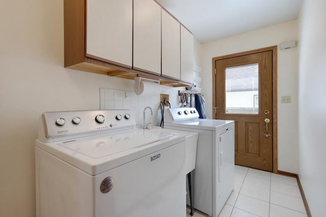 588 Montego Dr, Elk Grove Village, IL 60007 - laundry area with separate washer and dryer, cabinet space, and light tile patterned flooring