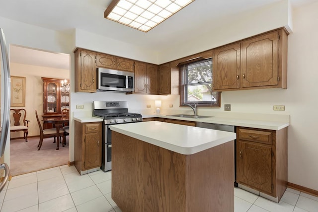 588 Montego Dr, Elk Grove Village, IL 60007 - kitchen featuring stainless steel appliances, light countertops, a kitchen island, and light tile patterned flooring