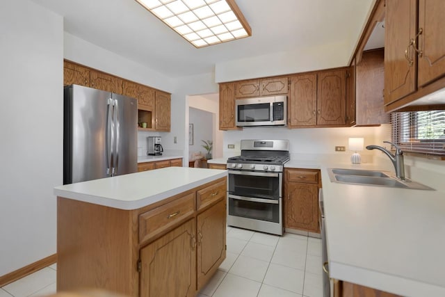 588 Montego Dr, Elk Grove Village, IL 60007 - kitchen featuring appliances with stainless steel finishes, light countertops, a center island, and brown cabinetry